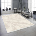 Modern beige and cream washable living room rug with subtle marble pattern, placed on light wood floor.