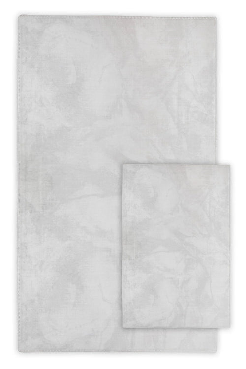 light grey washable area rugs with subtle marbled pattern, shown in two sizes