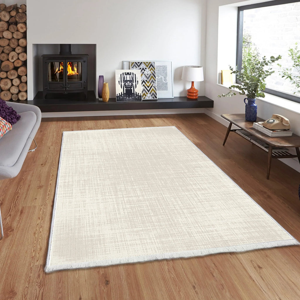 Light beige washable rug on wooden floor in modern living room with fireplace